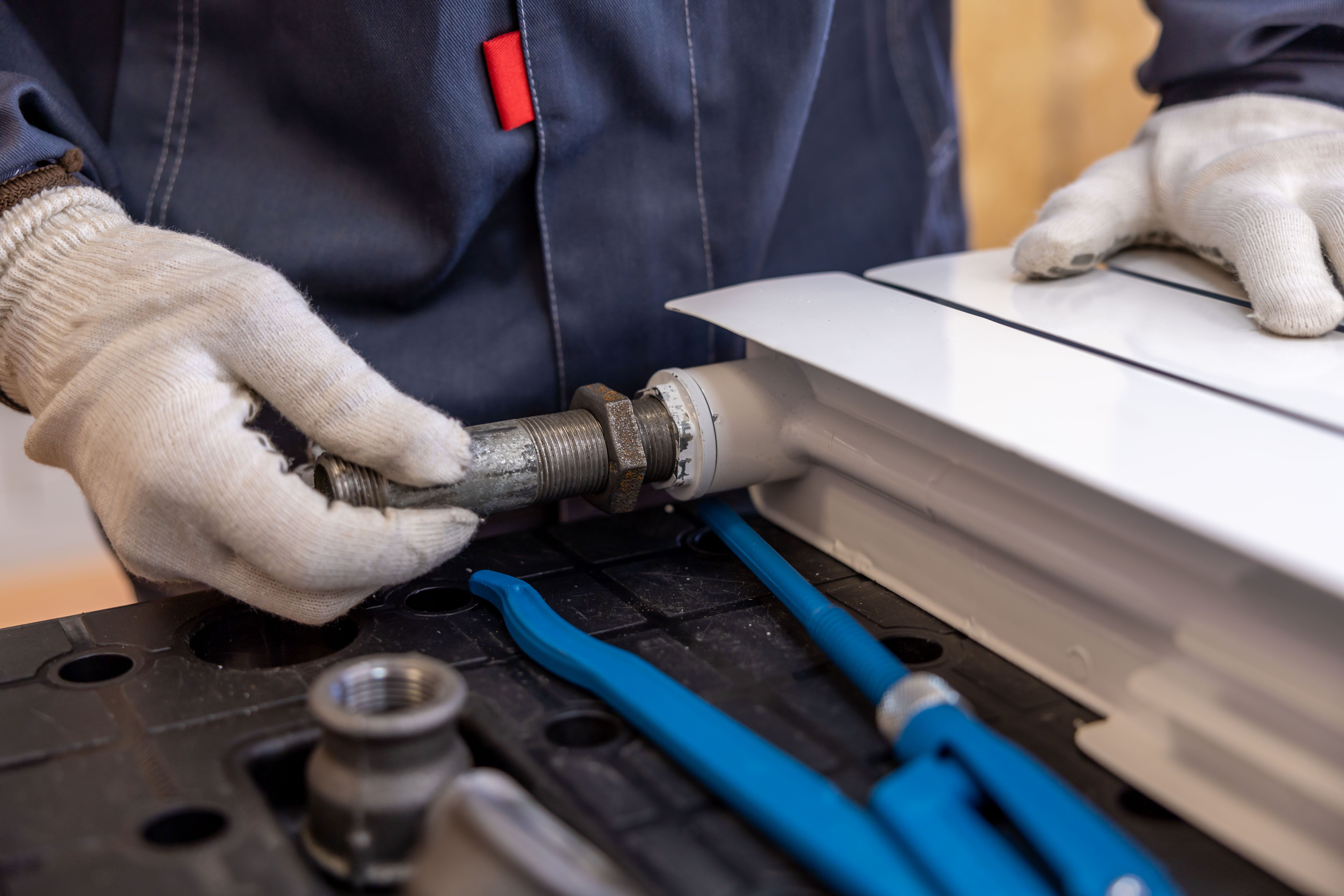 Professional plumber installing residential piping